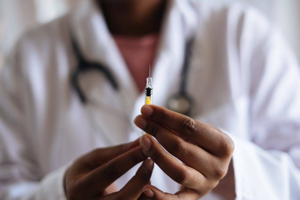 Person holding a vaccine.