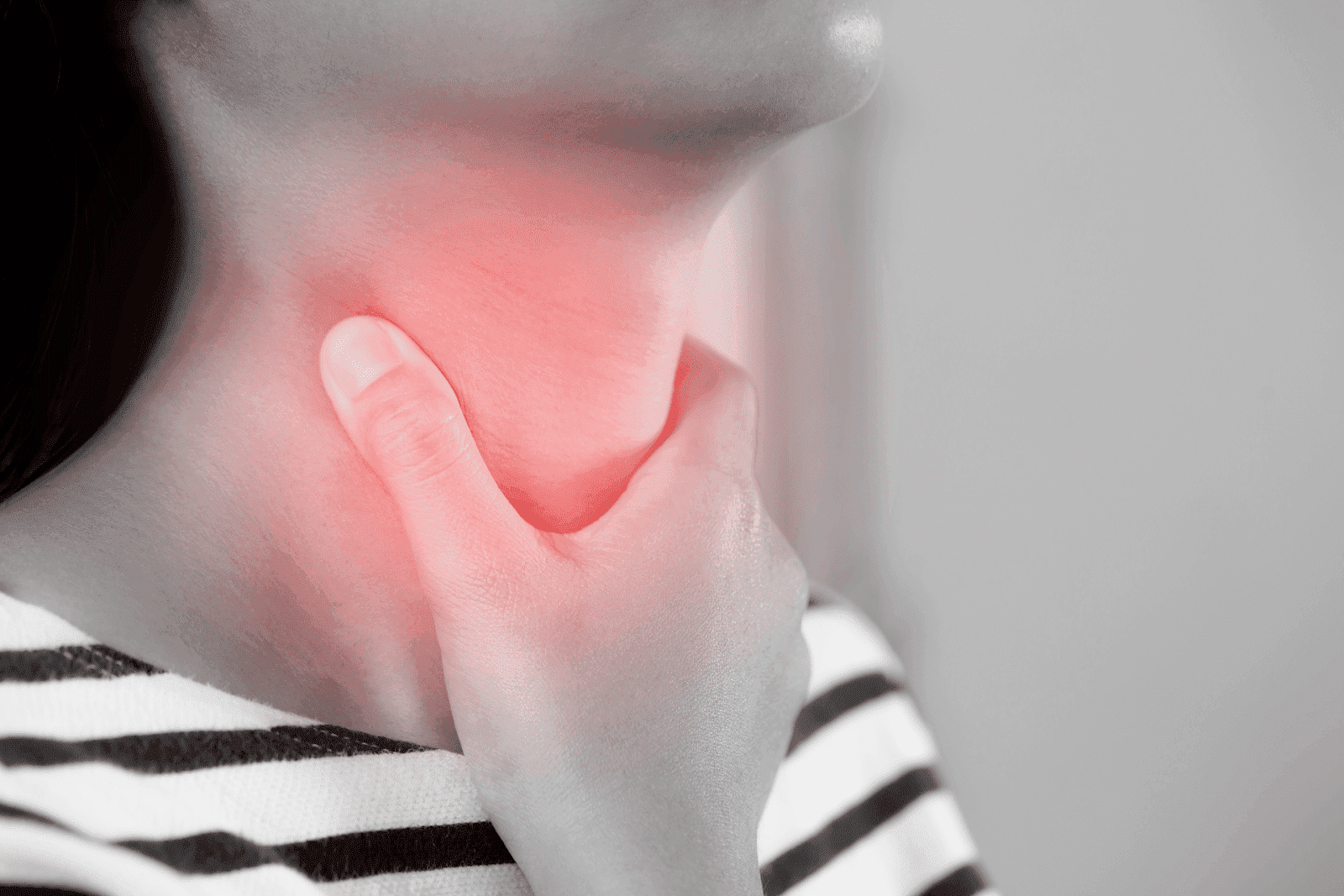 A close-up of a woman clutching her sore throat, with a red highlight indicating pain.
