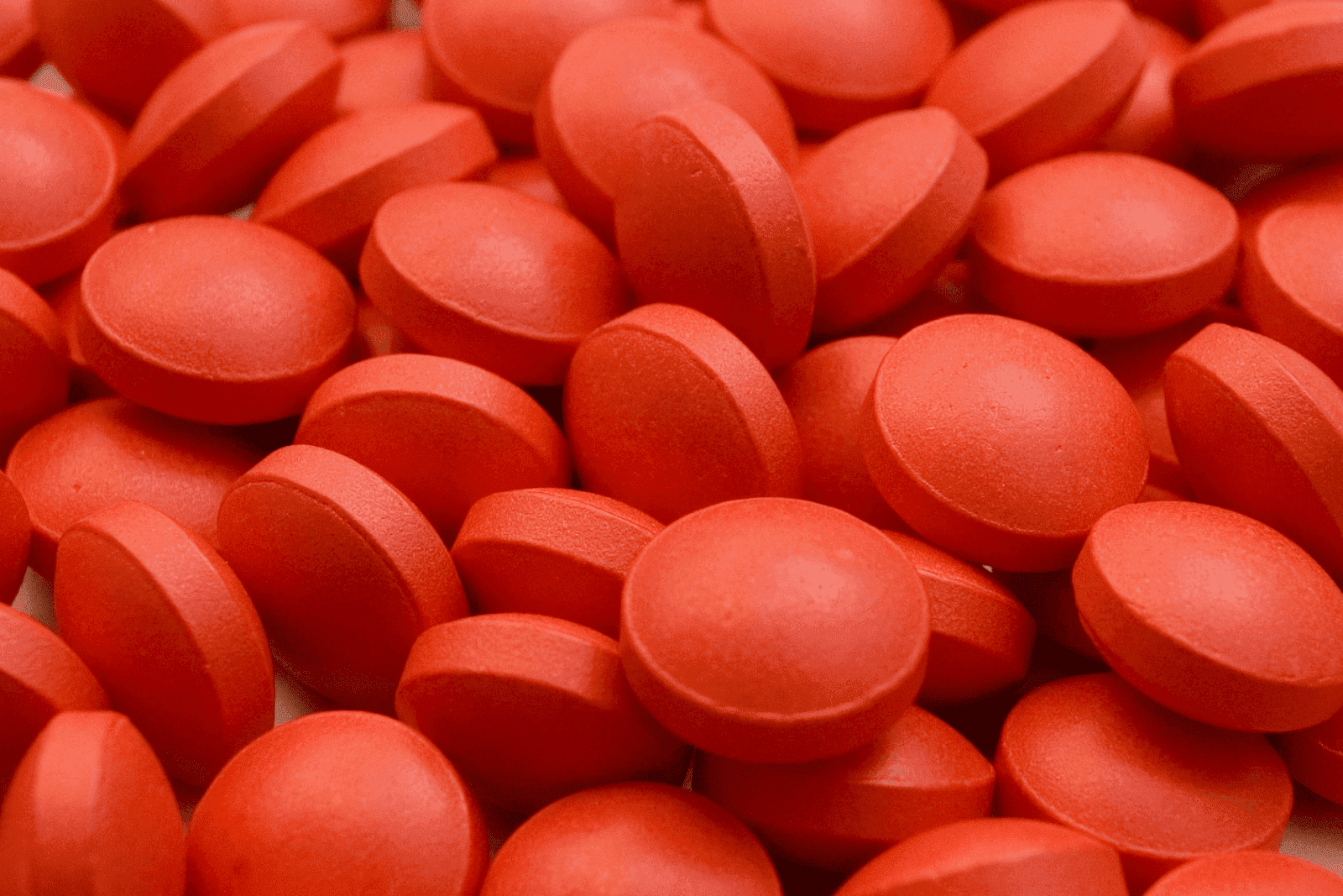 A small pile of round red tablets