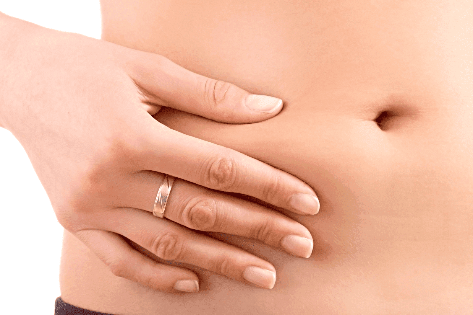 Close-up of a hand pinching skin near the stomach