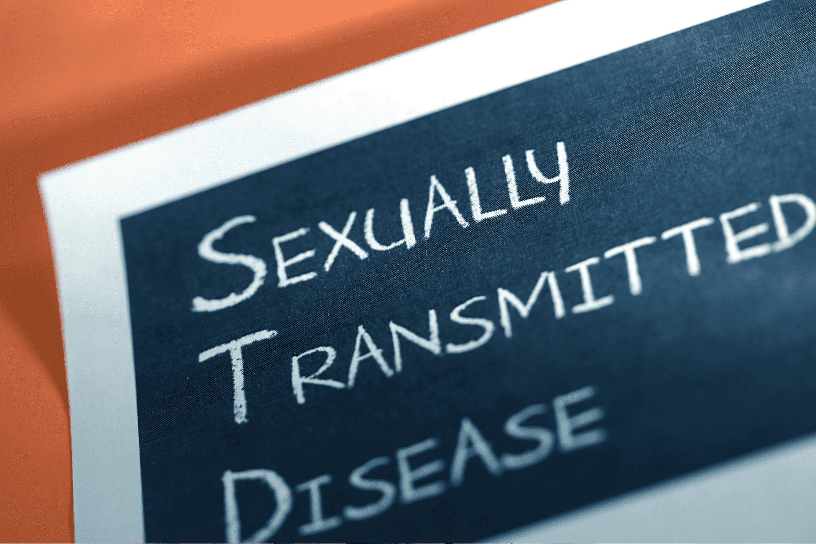Close-up of a paper showing the words "Sexually Transmitted Disease" written in white