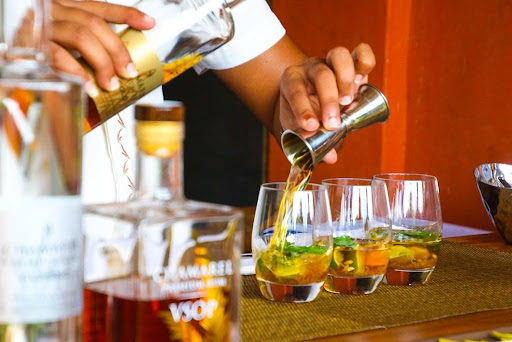 Person pouring a cocktail.