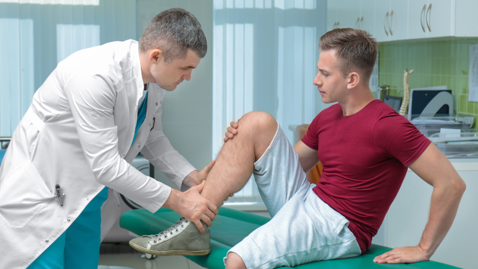 Doctor checking bottom of leg for a patient