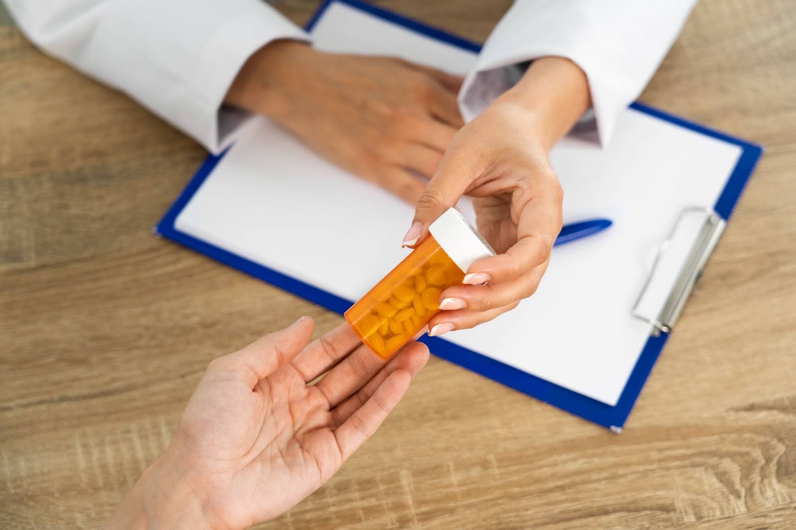 Doctor handing tablets