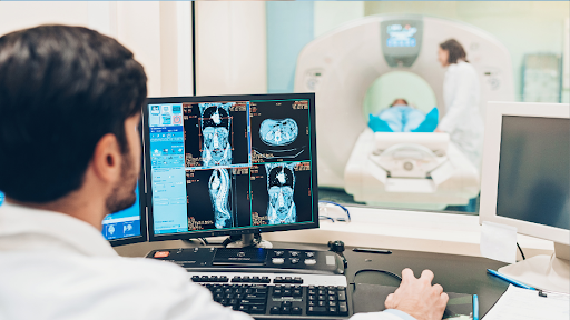 Doctor looking at computer screen showing MRI imaging