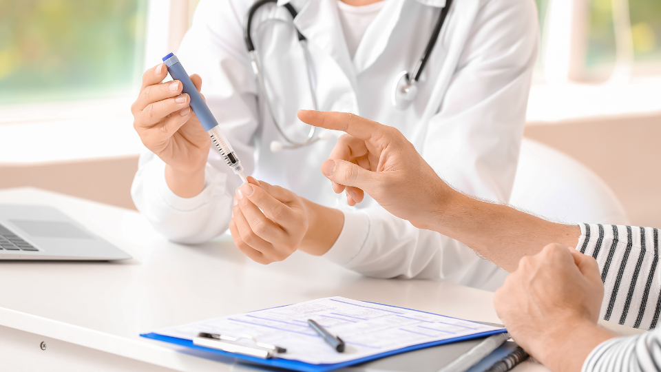 Doctor showing patient how to give shot of tirzepatide