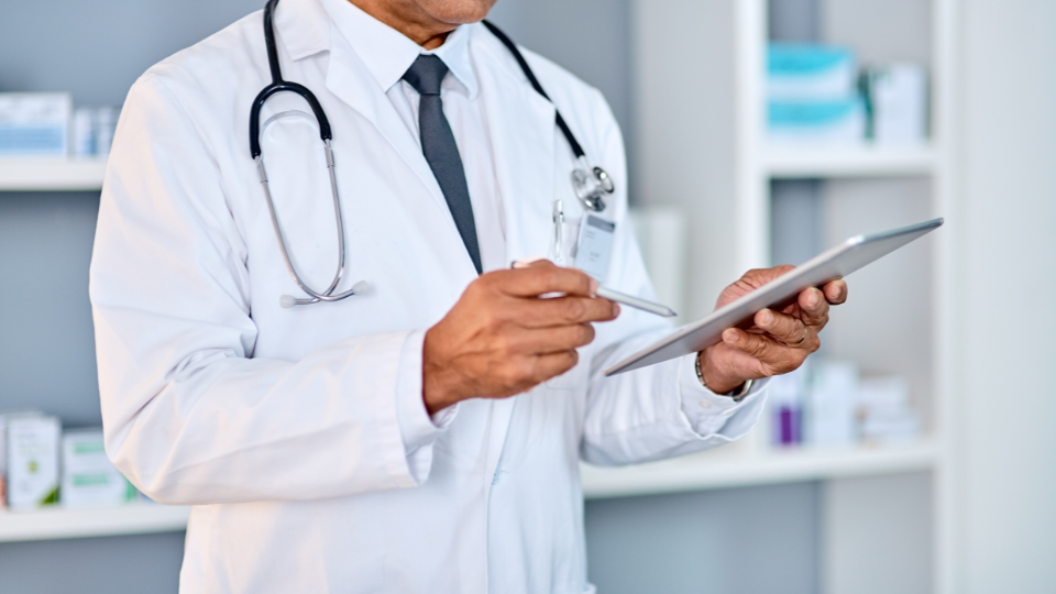 Male doctor using tablet