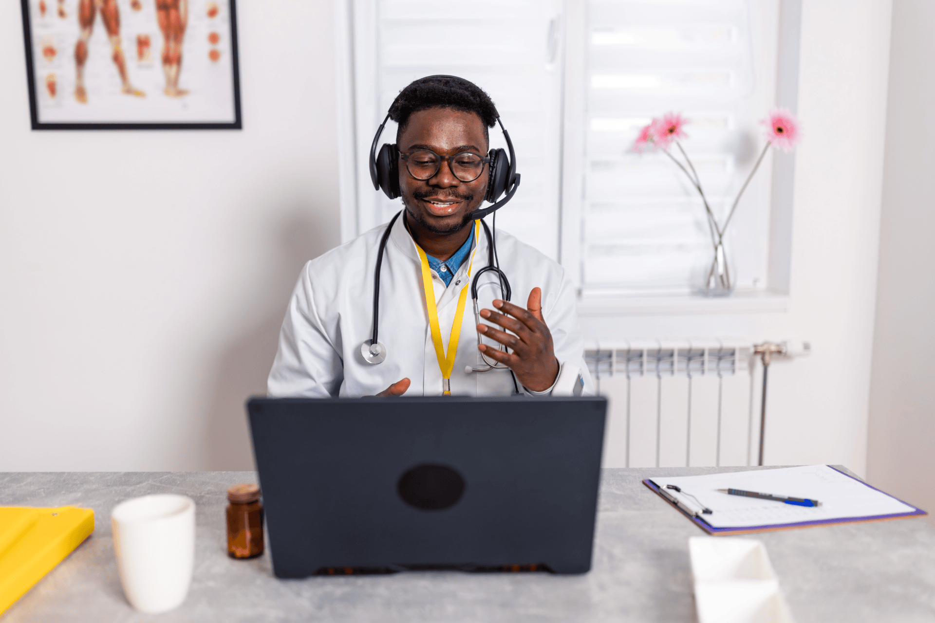 Doctor wearing a headset speaking to a patient during an online video consultation.