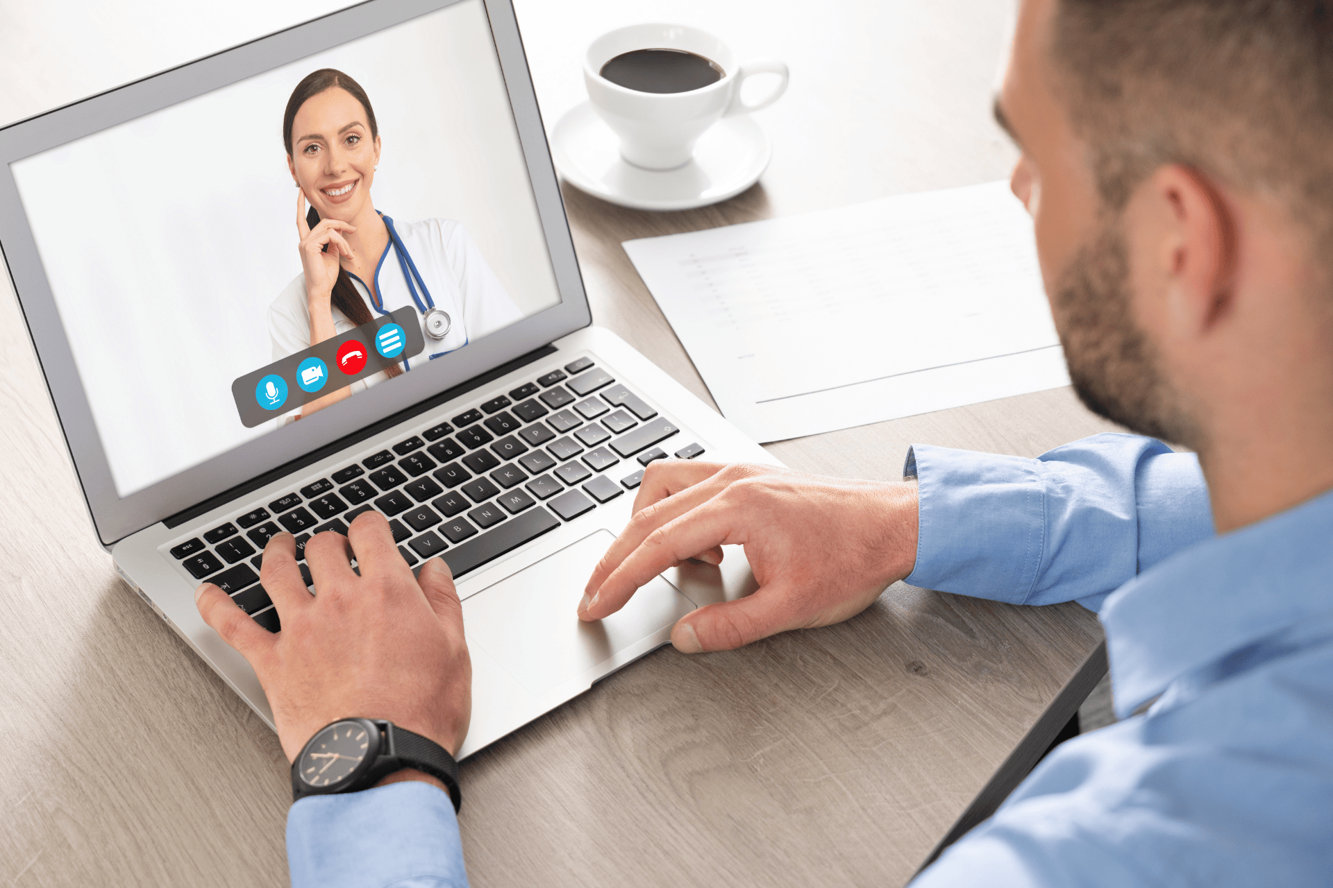 A Man having a video call with a smiling female doctor on his laptop.