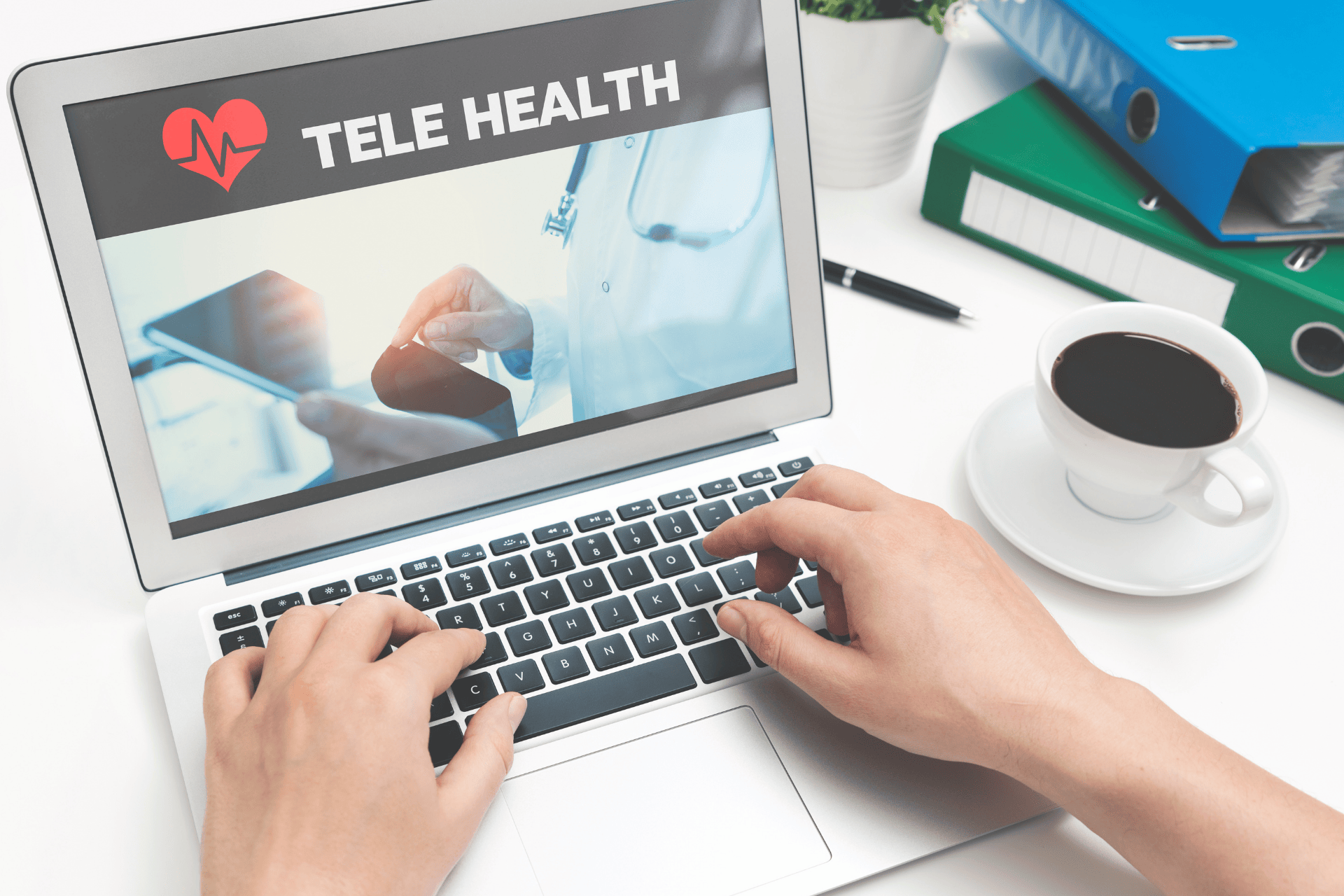 Person using a laptop showing a telehealth screen with a cup of coffee nearby.