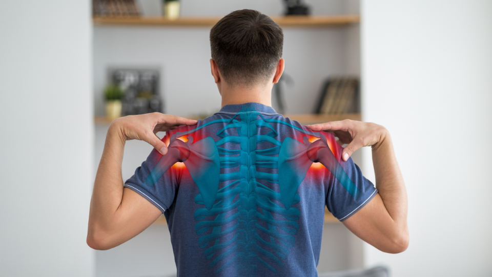 Man touching each shoulder with illustration highlighting areas of pain.
