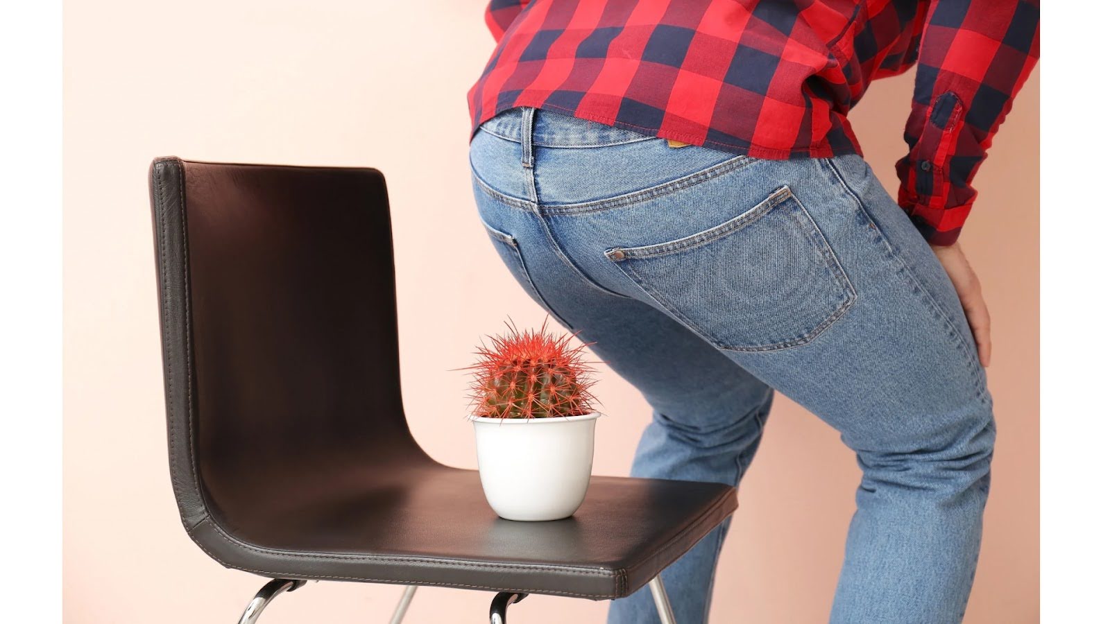 A man experiencing hemorrhoid pain like sitting on a cactus
