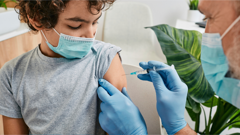 Child getting tetanus shot from doctor