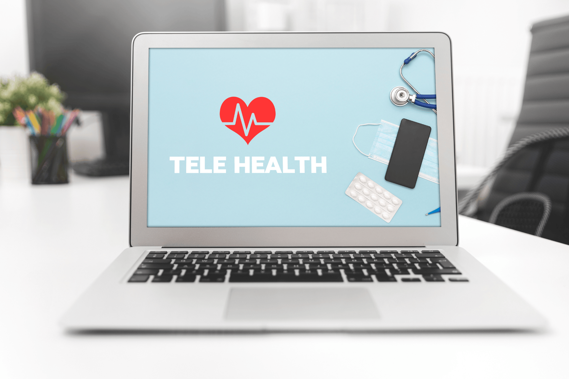 Laptop screen displaying a telehealth graphic with medical items beside it