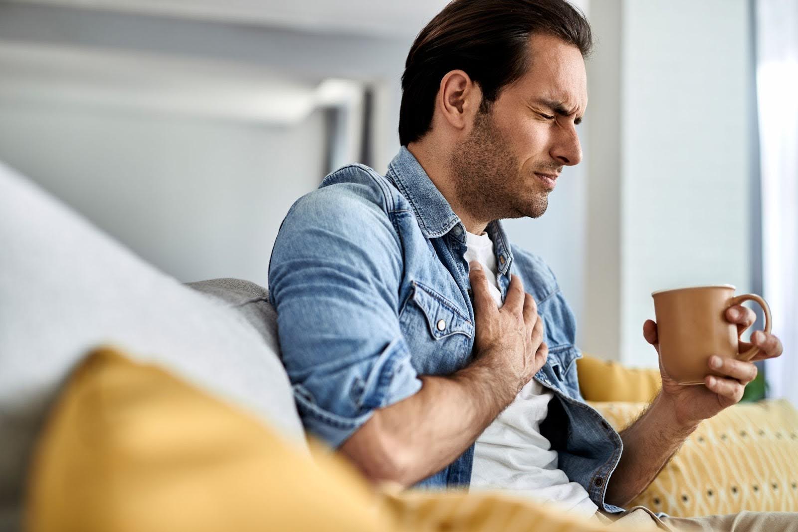 Young man feeling extreme chest pain
