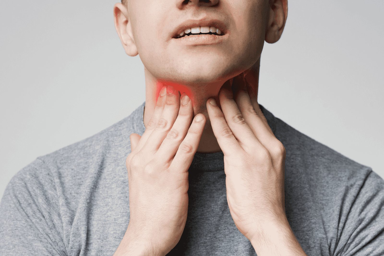 Man holding throat with red highlight showing inflammation