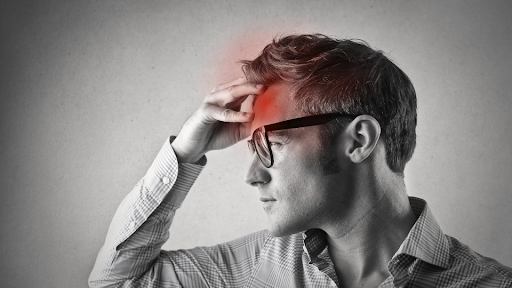 Man showing signs of a headache.