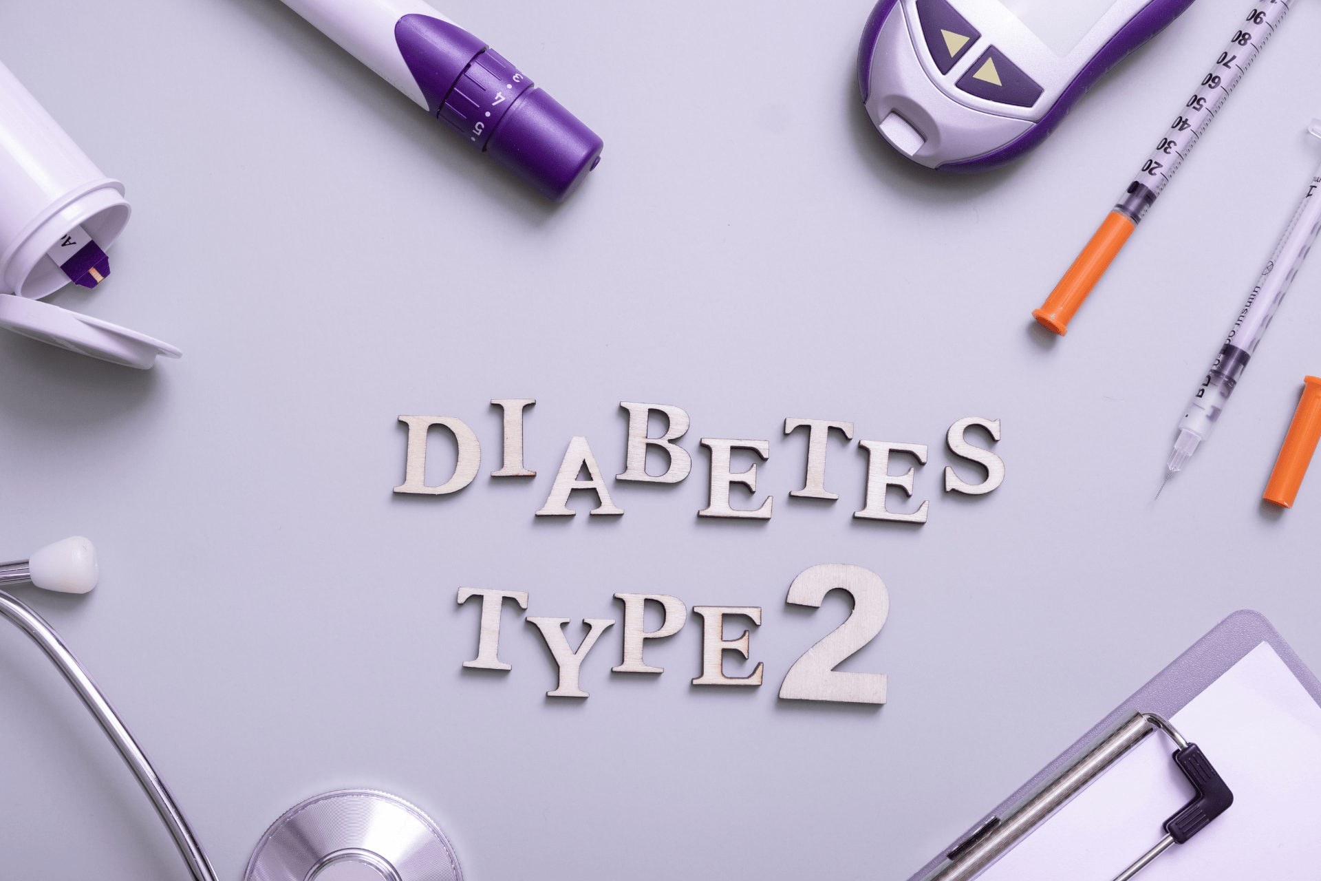 Medical tools and equipment arranged around the words ‘Diabetes Type 2’ on a light background.