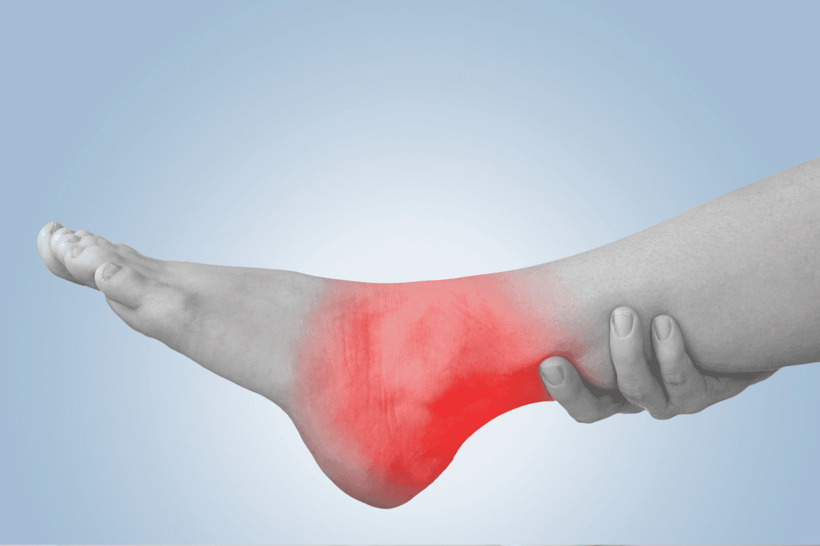 Monochrome photo of a foot with red overlay on the ankle, indicating pain or swelling