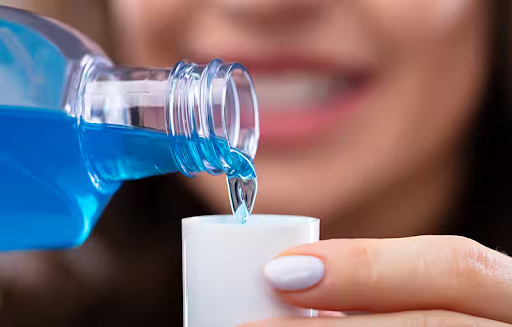 close-up of a woman using mouthwash for oral hygiene
