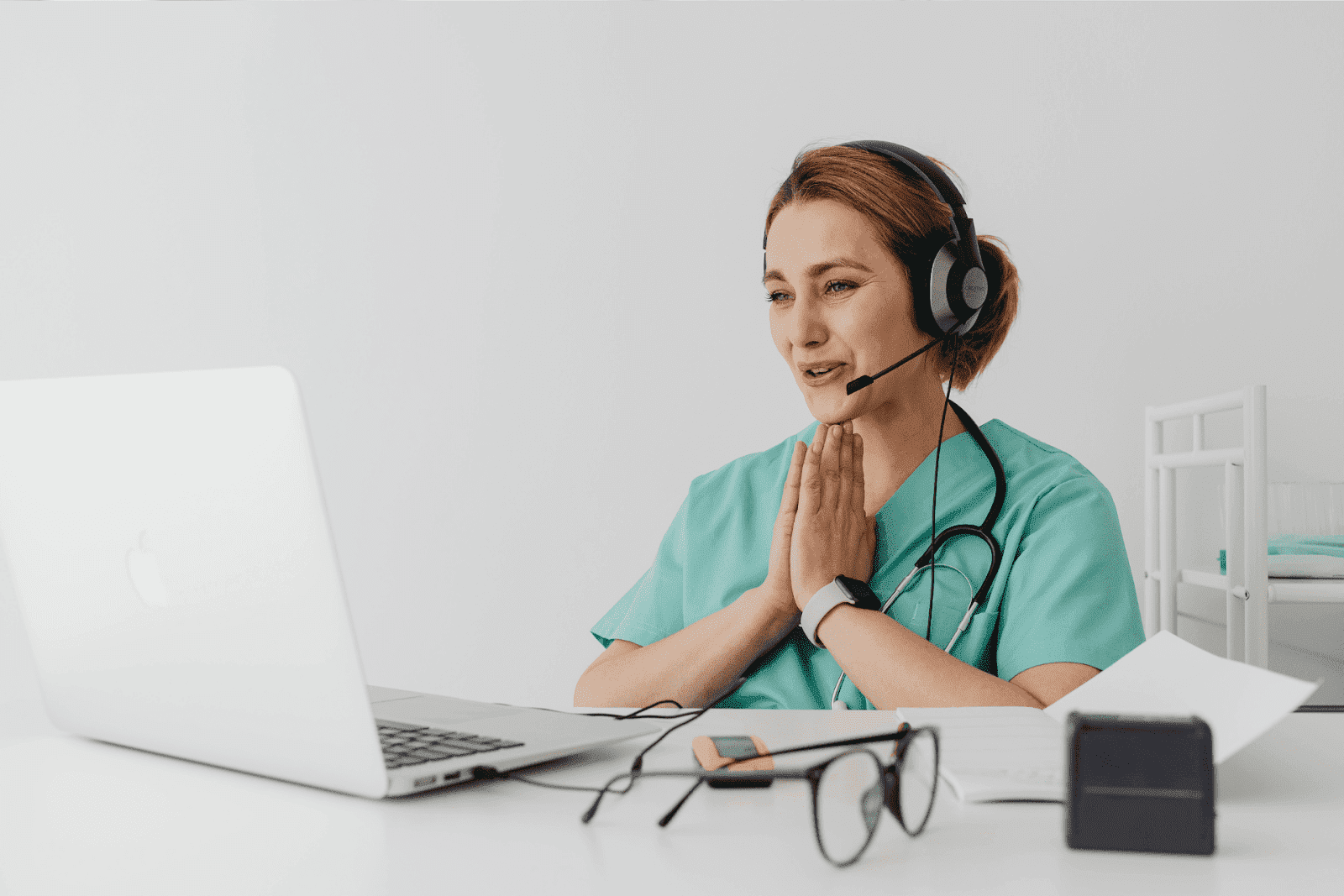 Nurse with a headset talking during an online consultation.