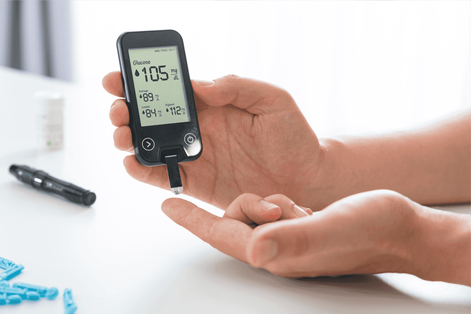 Person checking blood glucose level with a glucose meter.