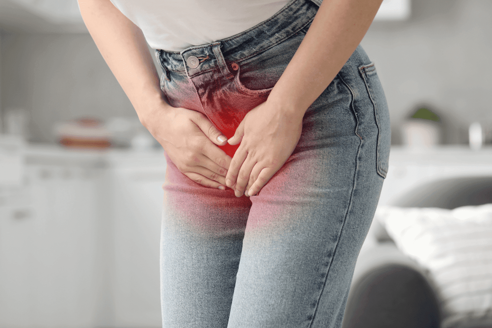 Person clutching lower abdomen with red highlight indicating UTI pain.