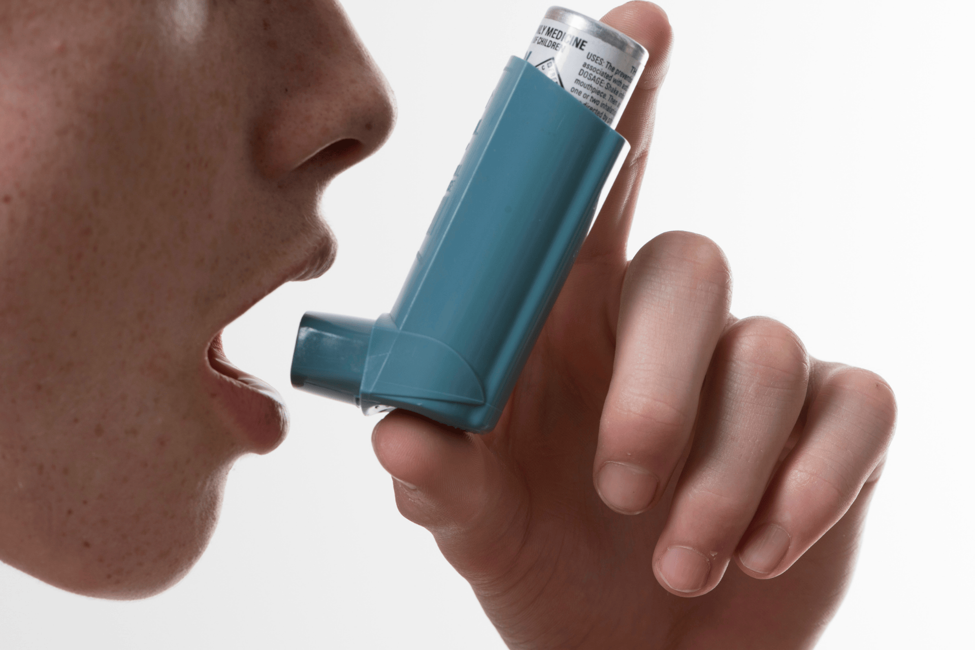 Person using a blue asthma inhaler