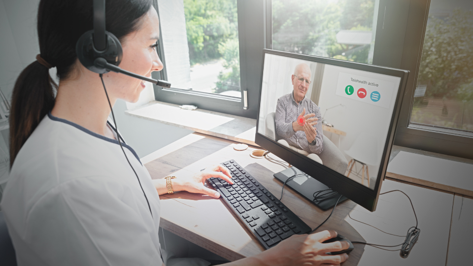 Doctor on telehealth call with elderly man.
