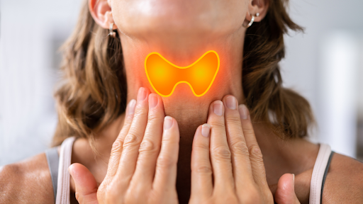 Women placing hands on neck below thyroid
