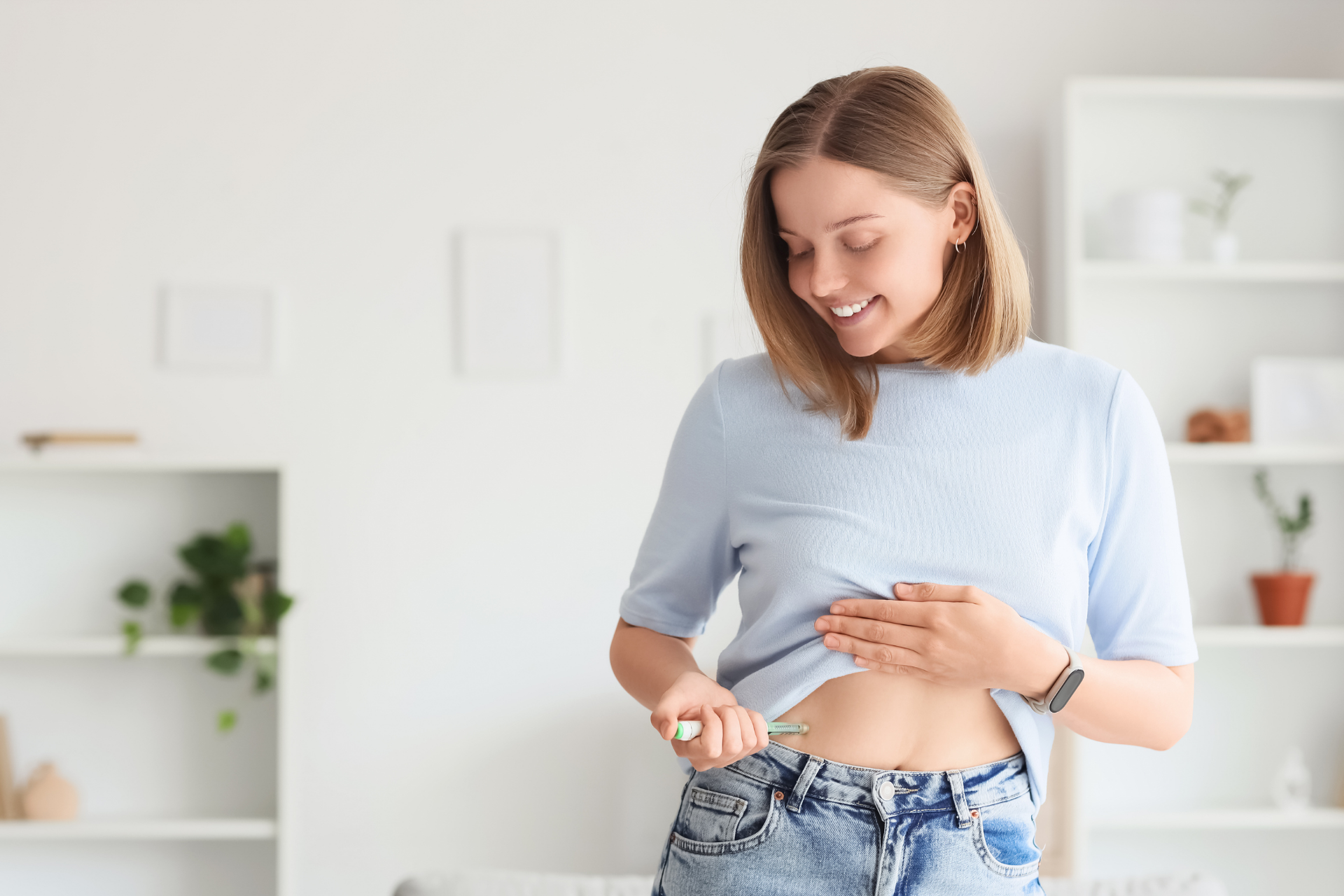 Woman smiling while giving herself a subcutaneous injection in the abdomen