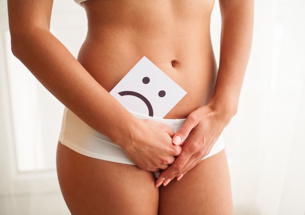 Woman covering her groin area