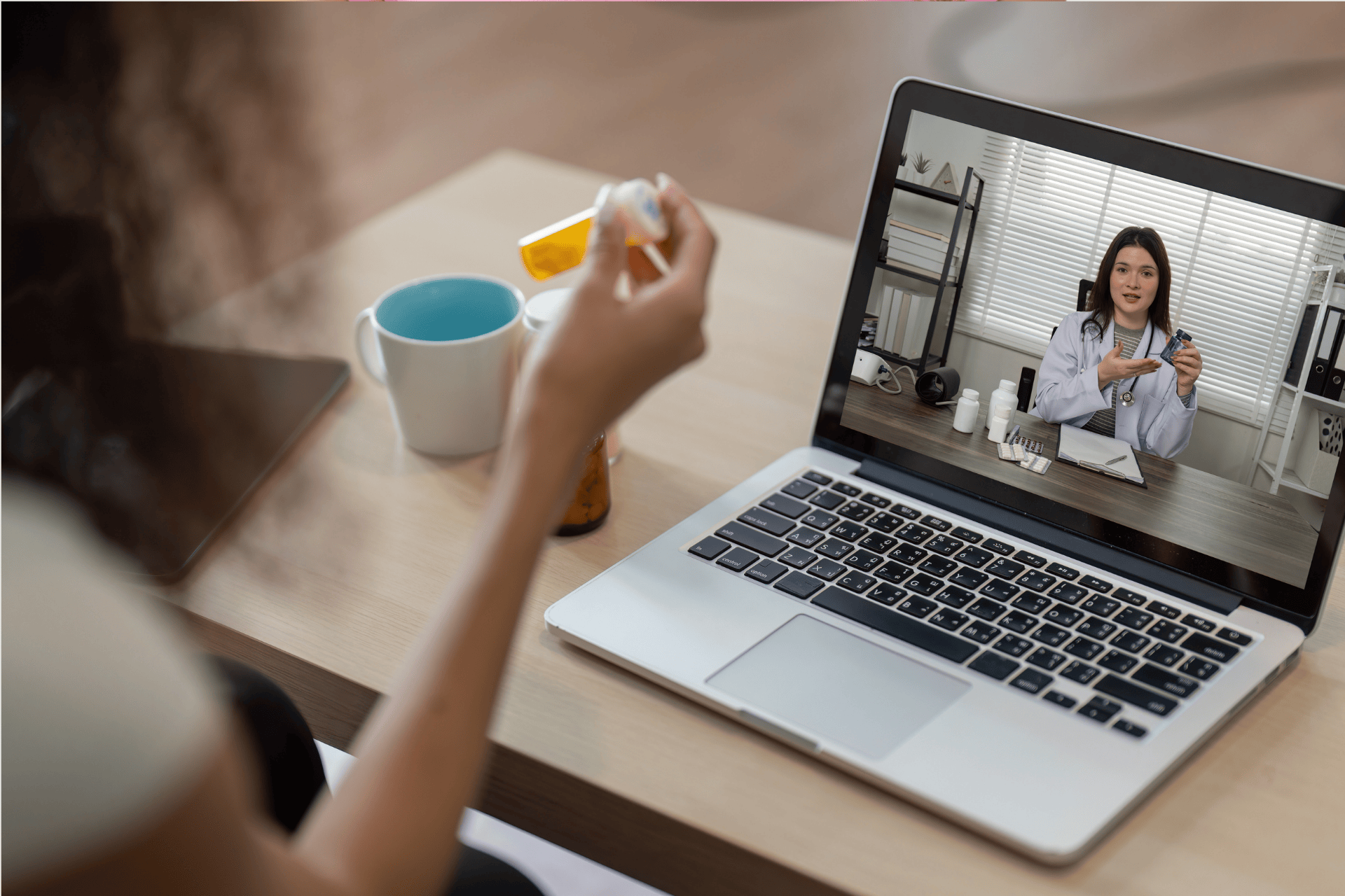 A Person having an online consultation with a doctor showing medication through a video call.