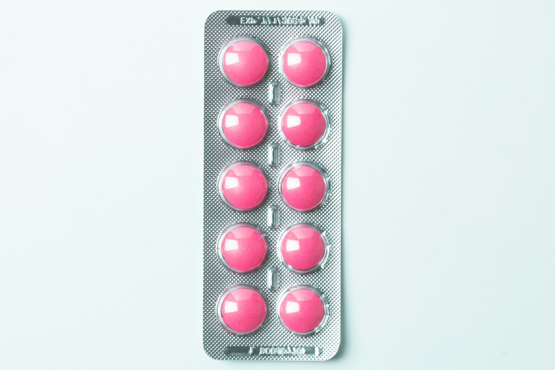 Blister pack of round pink pills.
