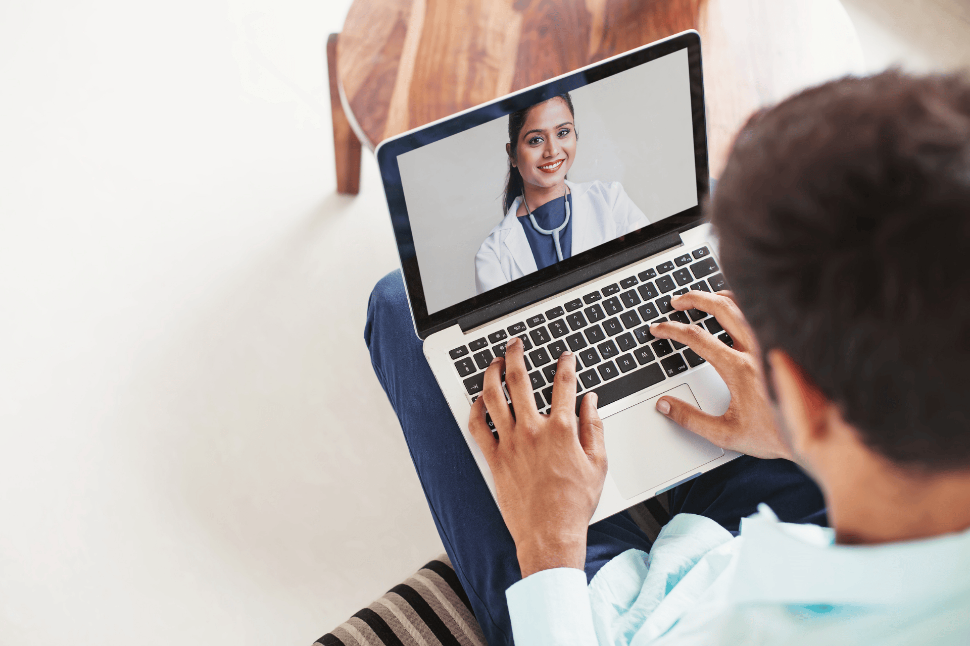 Person having a video call with a doctor on a laptop.