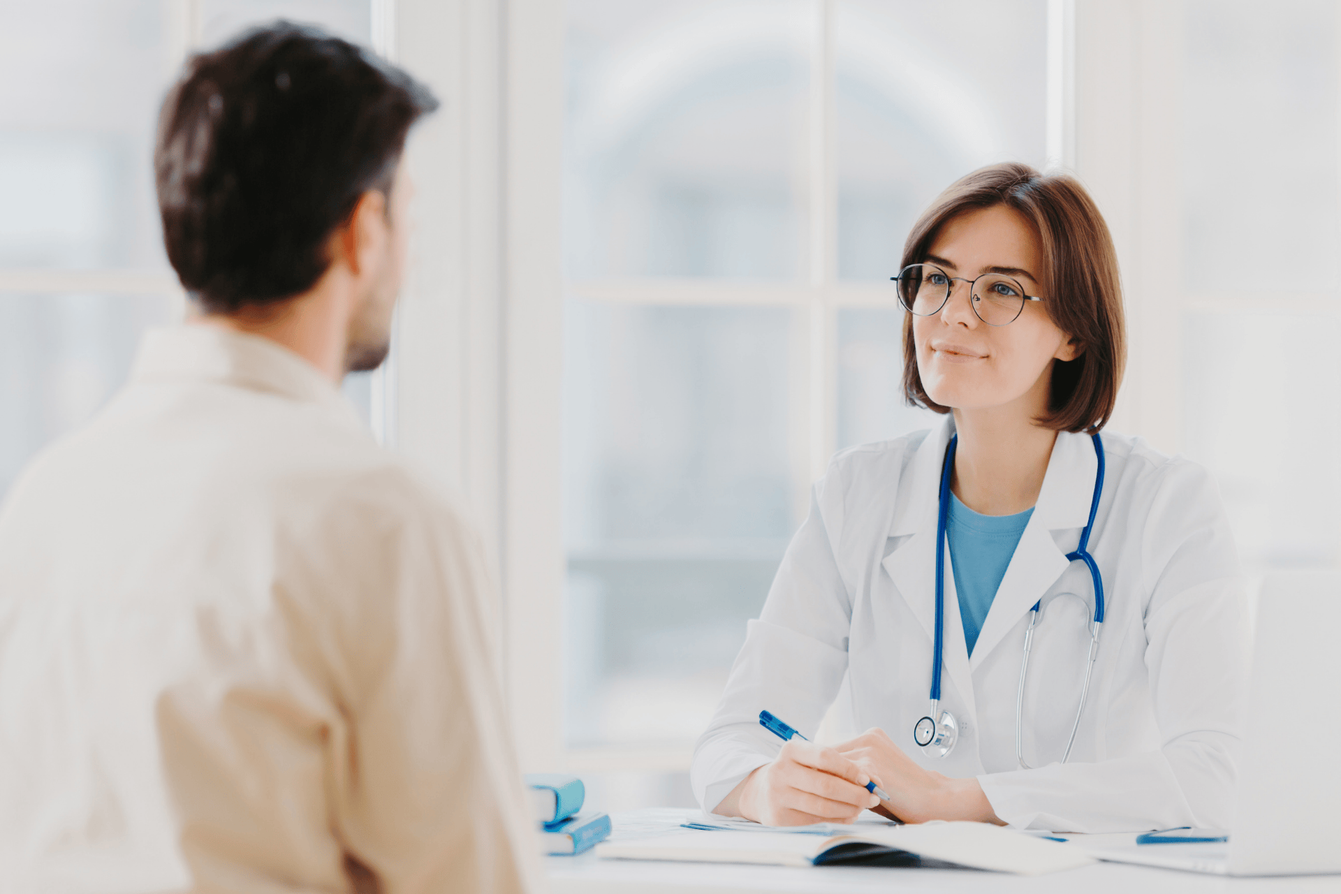 Doctor speaking with a patient during an office consultation.