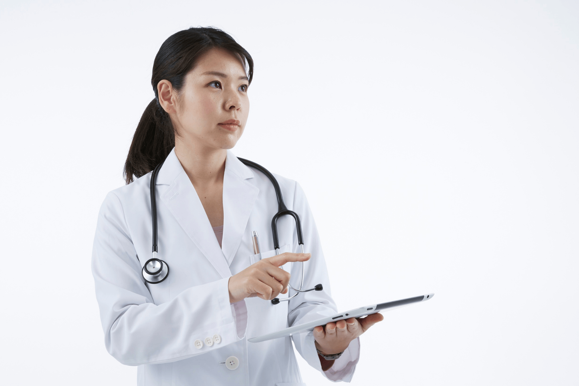 Female doctor holding a tablet and pointing at the screen.