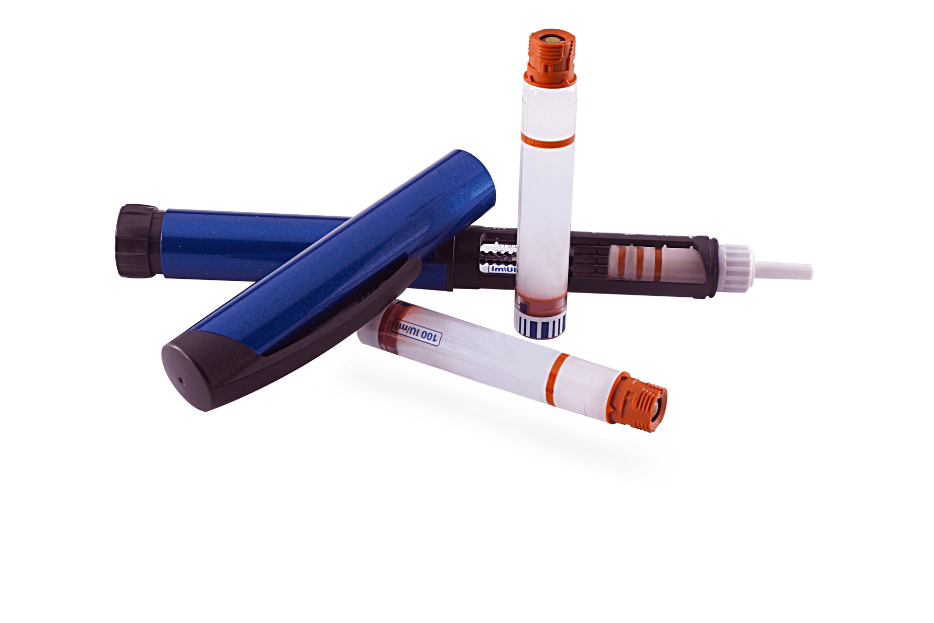 Close-up of insulin pens and cartridges on a white background.
