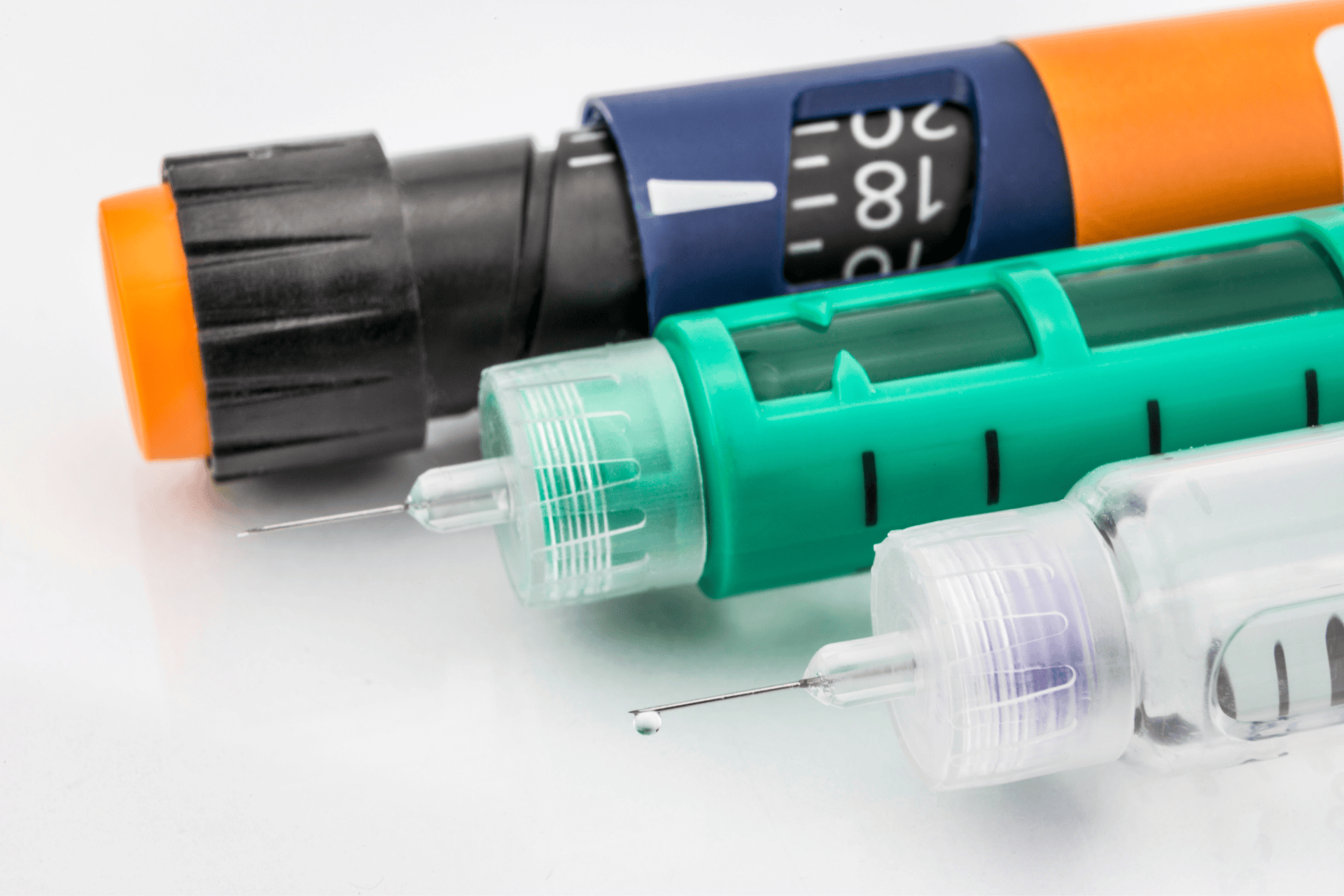 Close-up of insulin pens and syringes with visible needles.