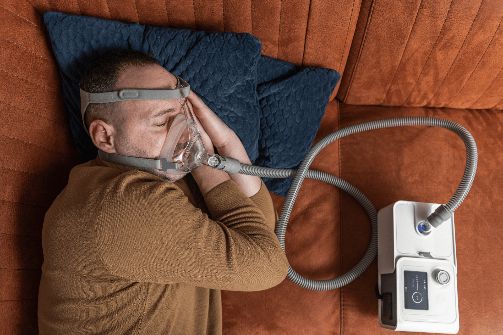 Man sleeping with a CPAP machine to manage sleep apnea.
