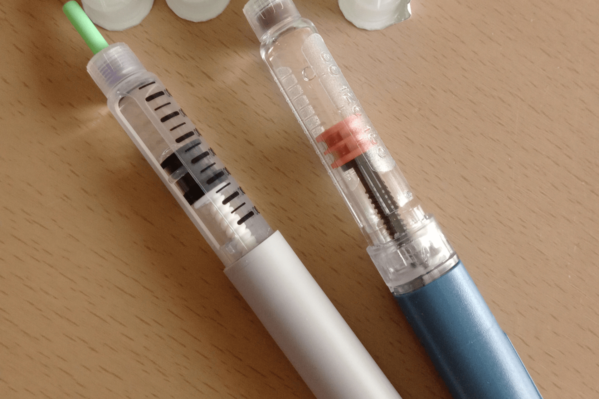 Insulin injection pens used for diabetes treatment, showing medication cartridges and dosage mechanisms for blood sugar control.