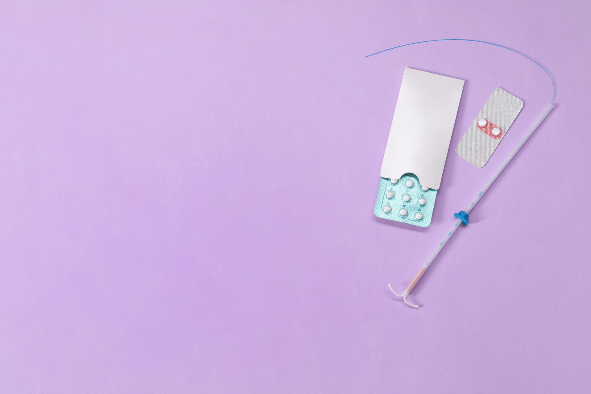Birth control items on a purple background, including pill packs and an intrauterine device (IUD) inserter.