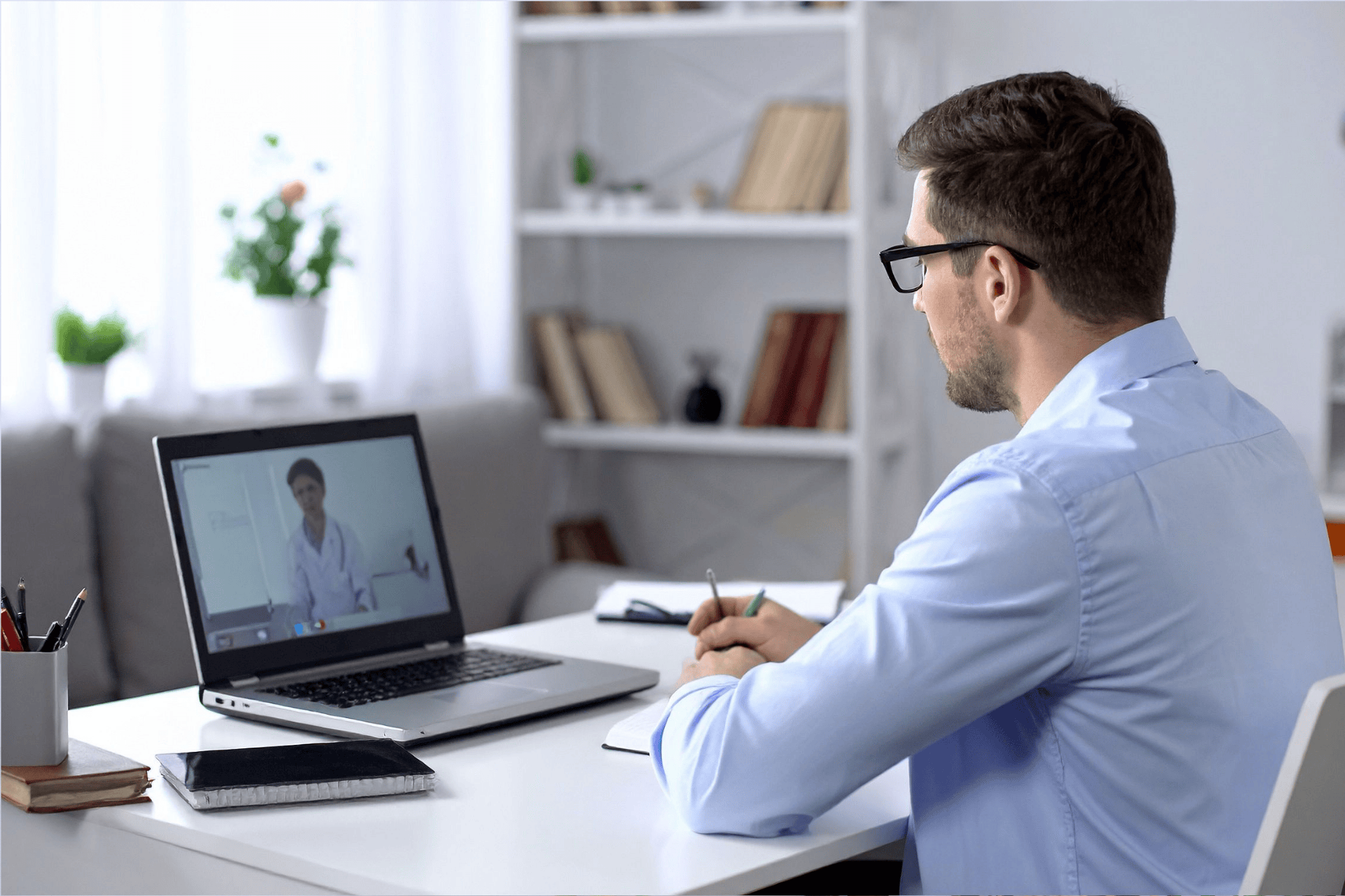 A Man having an online consultation with a doctor on his laptop.