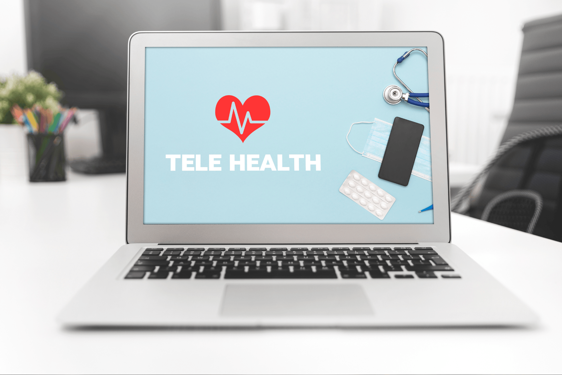 Laptop screen displaying a telehealth graphic with medical items beside it.