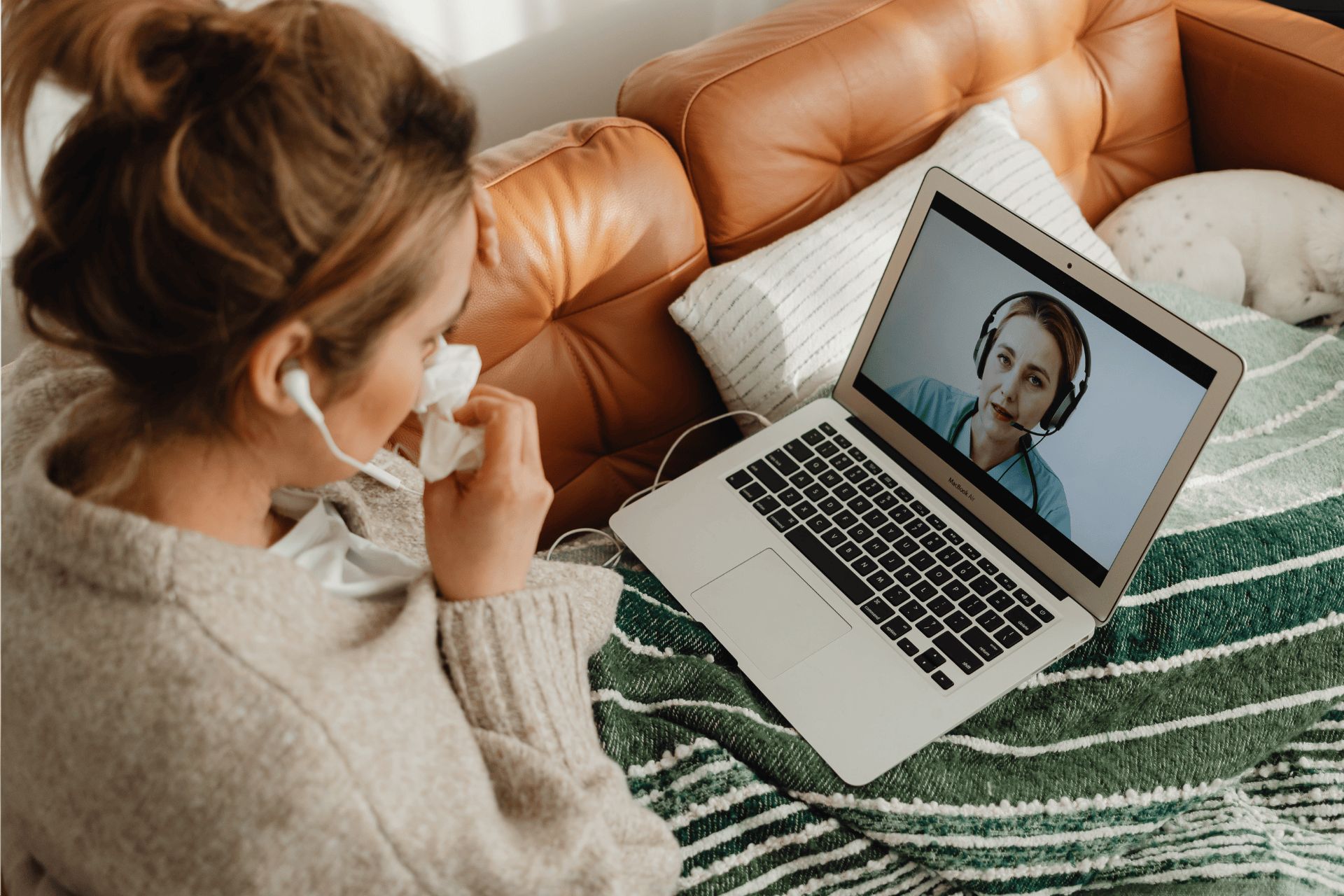 Sick woman having an online consultation with a doctor on her laptop.