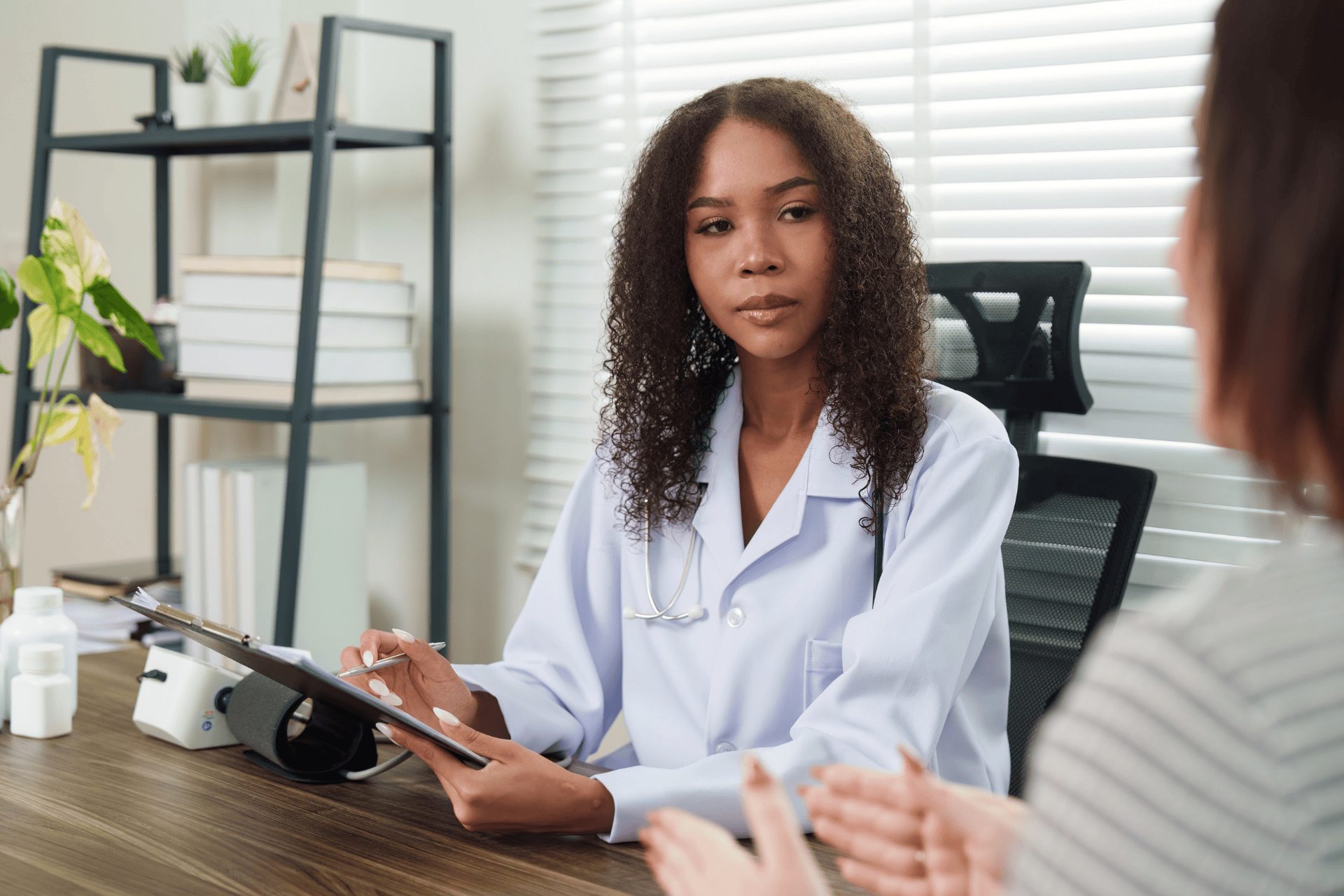 Doctor listening attentively to a patient during a consultation.