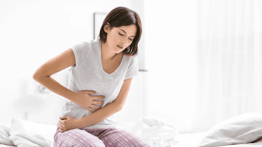 woman clutching her abdomen in pain