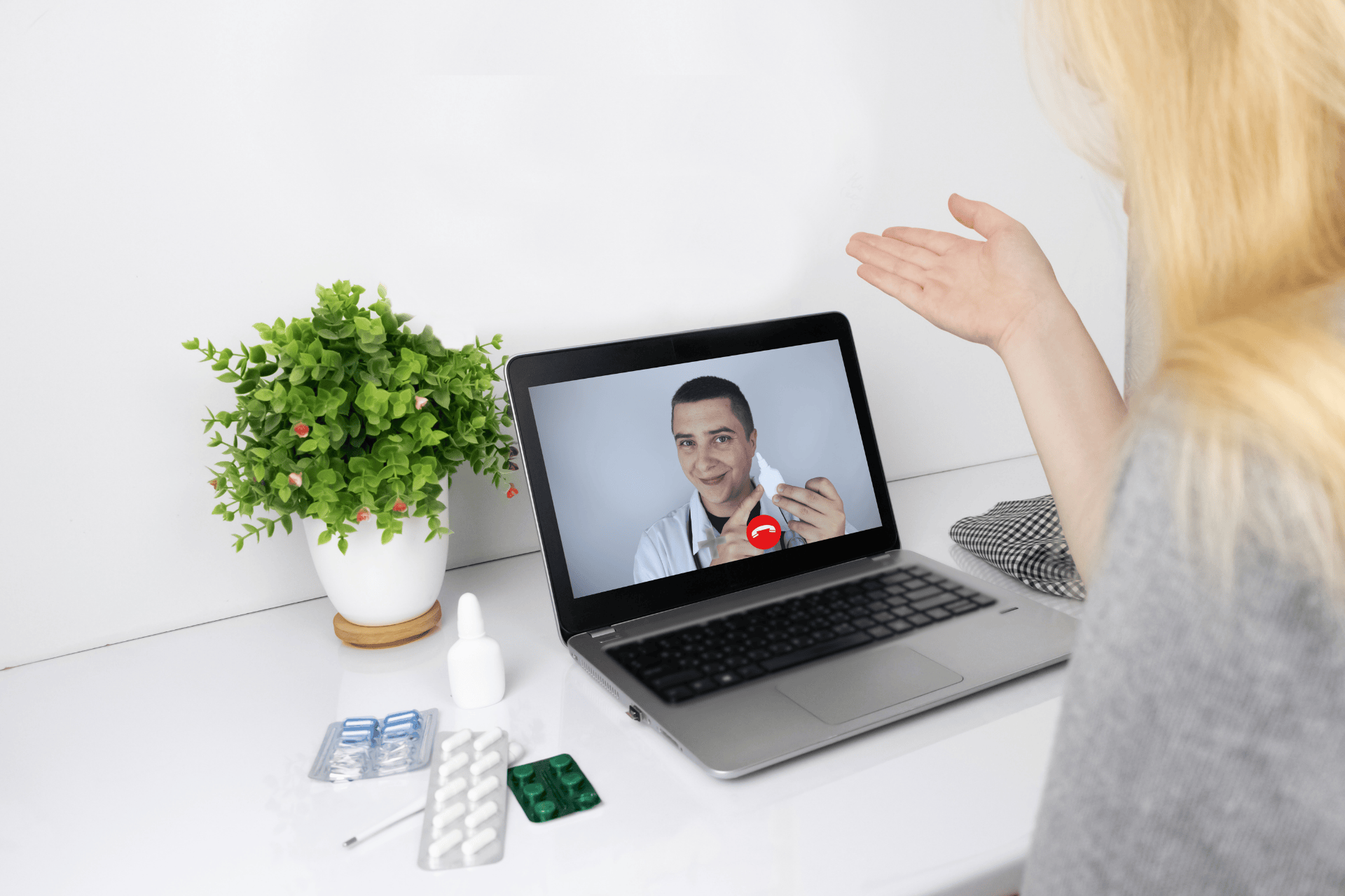 Woman consulting a doctor online about medication through a video call on a laptop.