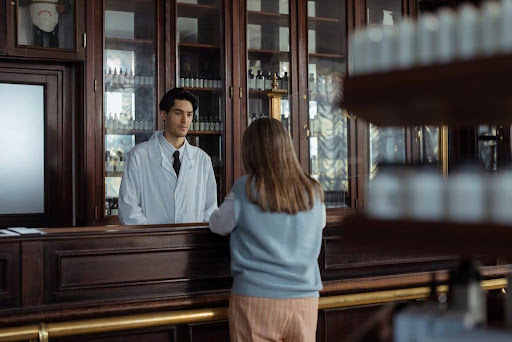 Woman talking to a pharmacist.