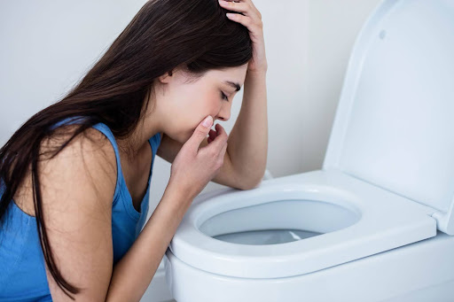 Girl throwing up in the toilet
